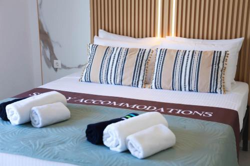 a couple of beds with folded towels on them at Apartment Simply 203 in Gázion