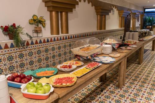 a buffet line with many different types of food at Hotel Faranda Express Puerta Del Sol Barranquilla, A Member of Radisson Individuals in Barranquilla