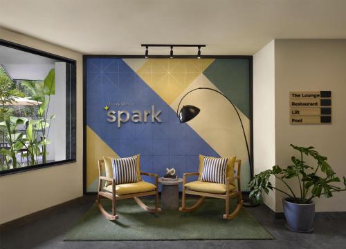two chairs and a table in a lobby at Spark By Hilton Goa Calangute in Goa