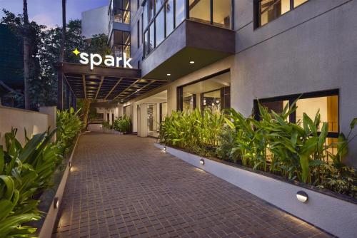 a walkway in front of a building with plants at Spark By Hilton Goa Calangute in Goa