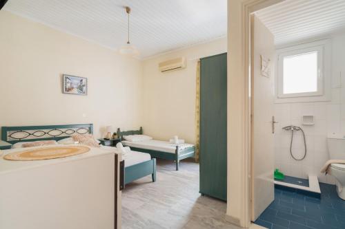 a bathroom with a sink and a toilet and a tub at Odysseia Beachside Apartments in Nikiana