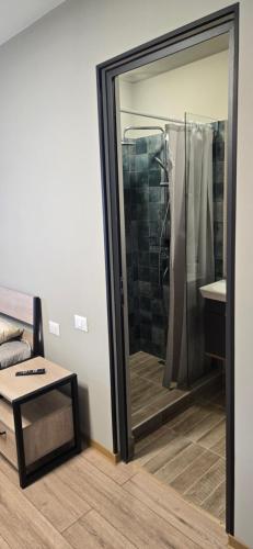a bathroom with a shower and a glass door at Ararat Terrace House in Ashtarak