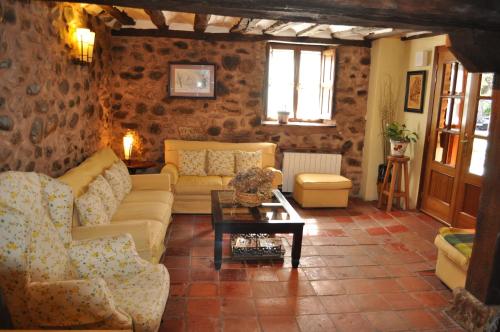 a living room with couches and a table at La Cuculla in Ezcaray