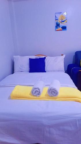 a bedroom with a bed with towels on it at Classic in Narok