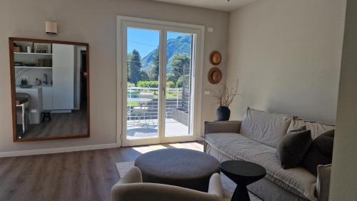 a living room with a couch and a mirror at Lake Como Terrace Suite in Mandello del Lario