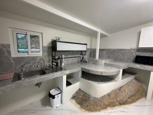 a kitchen with a sink and a counter top at Khao Raa Terrace @Phangan in Ban Madua Wan