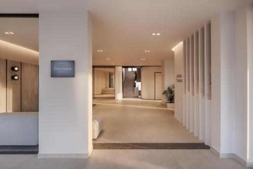 a hallway with white walls and a hallway with a hallway at Atlantica Thalassa Hotel in Kos