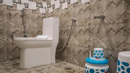 a bathroom with a toilet and a sink at Hotel Ganga Ram in Chitrakoot