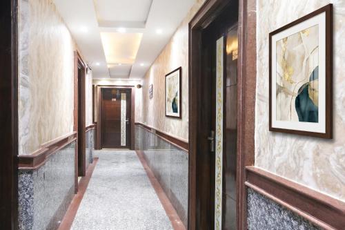 a hallway with paintings on the walls at FabHotel Dev Palace II - Nr Ashok Vihar in New Delhi