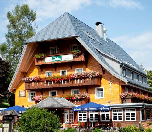 a building with flowers on the side of it at Hotel Adler Bärental in Feldberg