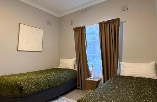 a bedroom with two beds and a window at Kimba Units - Better than a motel room - self contained and pet friendly in Kimba