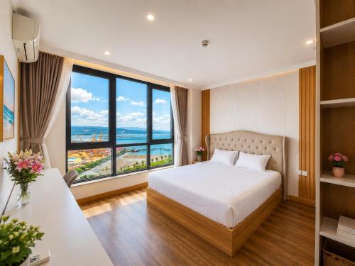 a bedroom with a bed and a large window at V Hạ Long in Ha Long