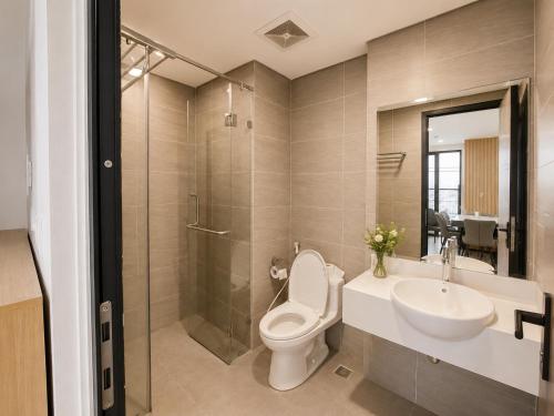 a bathroom with a toilet and a sink and a shower at V Hạ Long in Ha Long