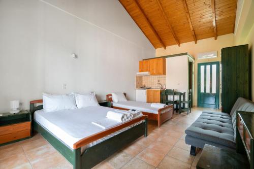 a bedroom with a bed and a couch in a room at Lenia Studios in Kalamitsi