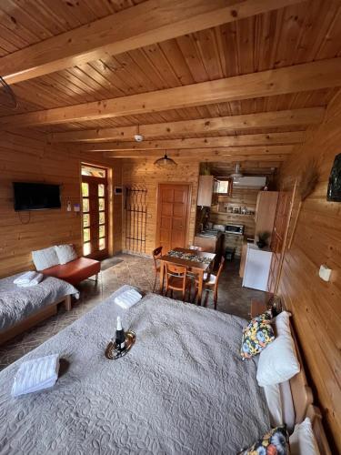 a living room with a large bed in a cabin at Petőfi 35 Vendégház in Sirok