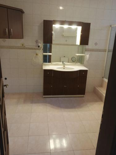 a bathroom with a sink and a mirror at Corner Park Suites City Center Corlu in Çorlu