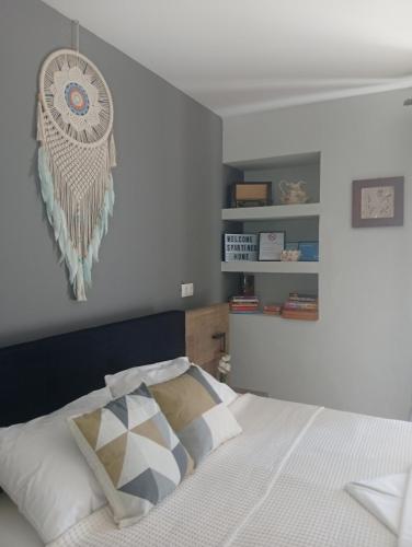 a bedroom with a bed with a dream catcher on the wall at Spartines home in Votsi