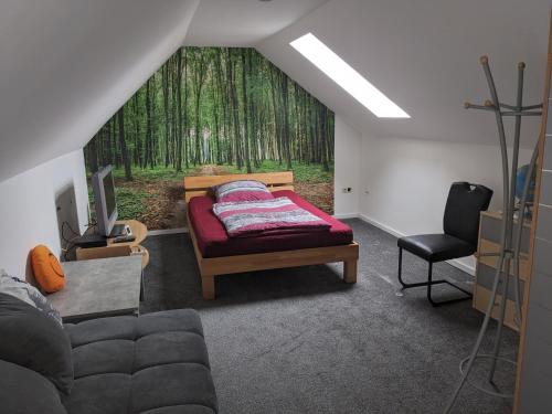 a living room with a bed and a window with trees at Ferienwohnung Lang in Nittenau