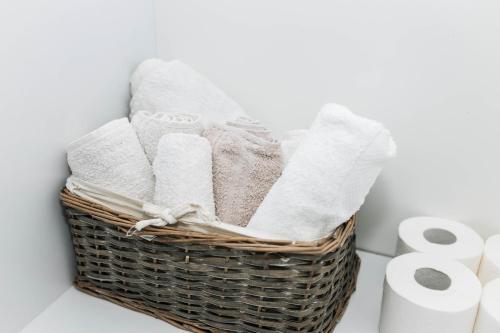 a basket filled with towels on a counter next to toilet paper at Lorena 21 Central in Bileća