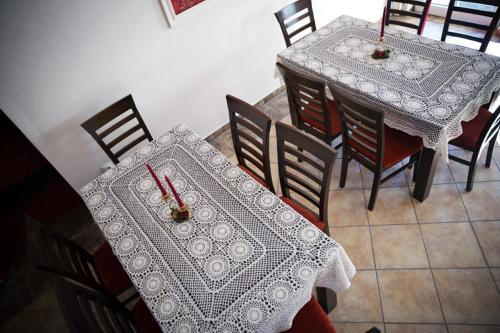 a dining room with two tables with red candles on them at Willa i domki Victoria in Wisła