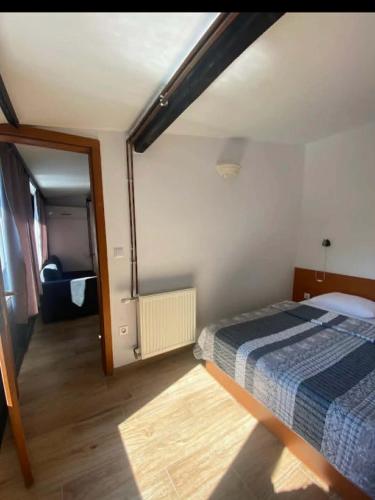 a bedroom with a bed and a large mirror at Camp Rooms in Jajce