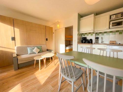 a kitchen and living room with a table and chairs at Residence Pierre & Vacances Les Embruns in Deauville