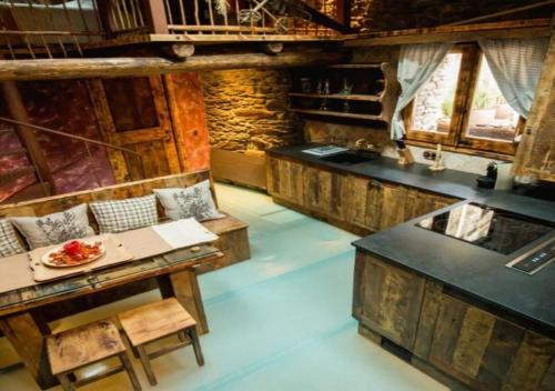 a kitchen with wooden counters and a sink in a room at Casa Rural Mariola in Ordino