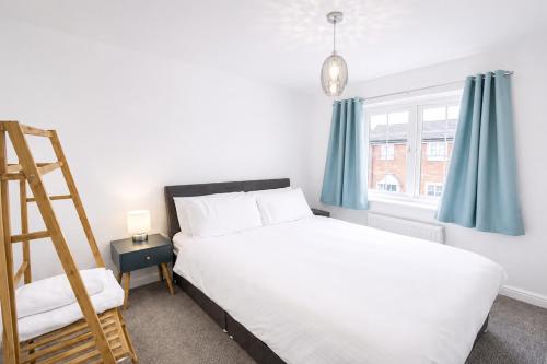 a bedroom with a bed and a ladder and a window at Grantham Stays - Dexter - 3BR, Sleeps 5, Parking & WIFI in Grantham