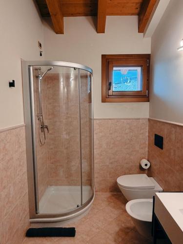 a bathroom with a shower and a toilet at Residenza Monticelli in Lavagno
