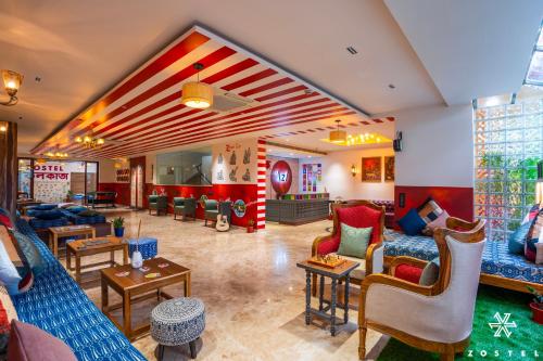 a large living room with couches and chairs at Zostel Kolkata in Kolkata