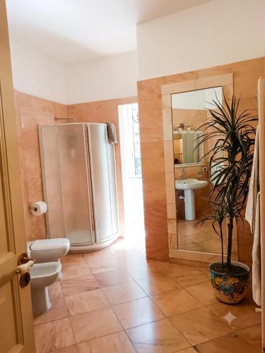 a bathroom with a stainless steel refrigerator and a potted plant at Chez Marie Ischia in Forio d'Ischia