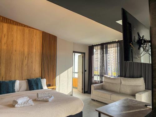 a bedroom with a bed and a couch at Boutique Palacio in Alicante