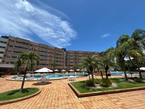 a resort with a pool and palm trees and a building at Gran Lençóis Flat Residence - Flat 302 in Barreirinhas