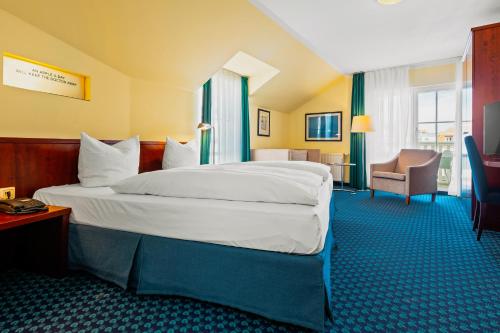 a bedroom with a large bed in a hotel room at Neptun Hotel Kühlungsborn in Kühlungsborn