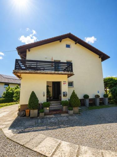 a house with a balcony on top of it at Apartma Tanja bike-friendly in Limbuš
