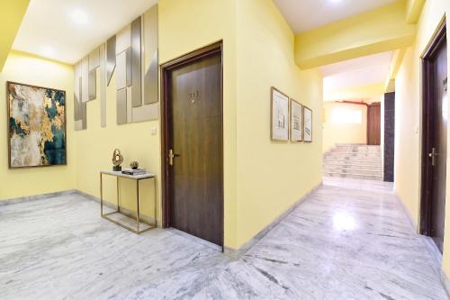 a hallway with a wooden door and a table at FabHotel Kirara - Nr Jaipur International Airport in Jaipur