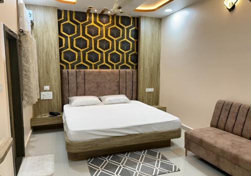 a bedroom with a bed and a couch at Hotel Ganga Ram in Chitrakoot