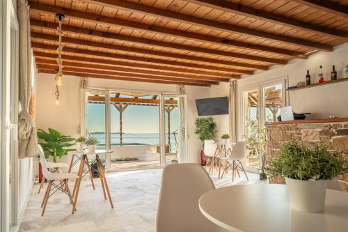 a living room with a table and a view of the ocean at Silia Dream View in Houlakia