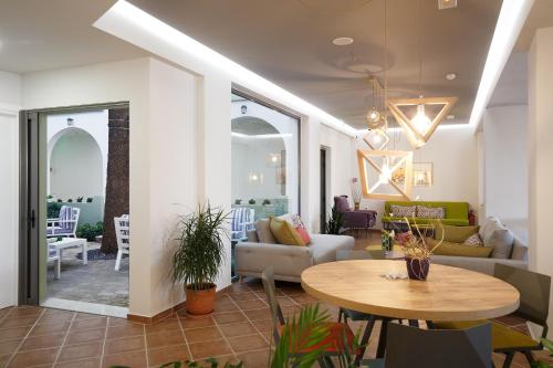 a living room with a table and a couch at Alianthos Garden in Plakias