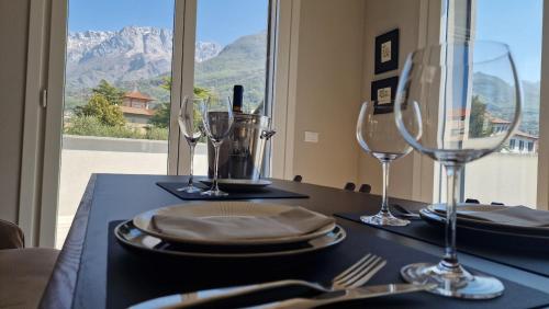 a table with wine glasses and a table with a view at Lake Como Terrace Suite in Mandello del Lario