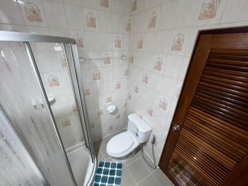a bathroom with a toilet and a shower at Bungalow Apartment Kamala in Phuket