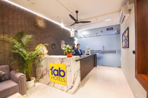 a woman sitting at a reception desk in an office at FabHotel Prime The Ballroom - Near GD Goenka University in Gurgaon
