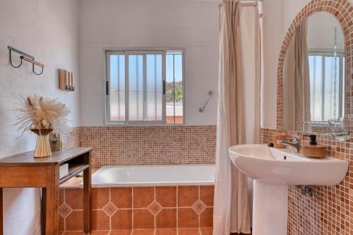 a bathroom with a tub and a sink and a shower at Casa Azafranes - Boutique B&B - Arenas in Arenas