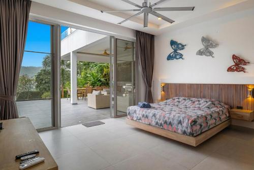 a bedroom with a bed with butterflies on the wall at The Palm Oasis in Lamai