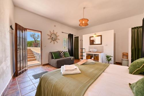 a bedroom with two beds and a living room at Casa Azafranes - Boutique B&B - Arenas in Arenas