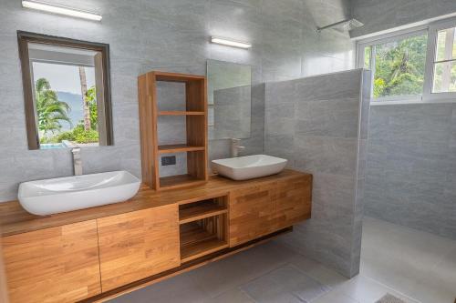 a bathroom with a sink and a mirror at The Palm Oasis in Lamai