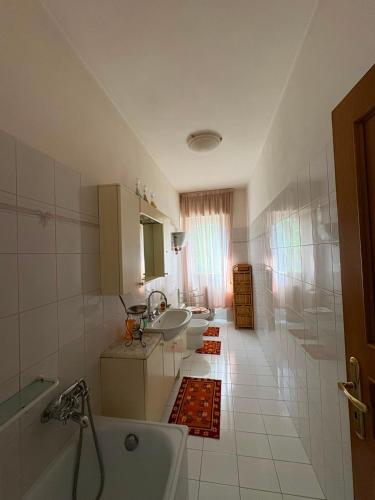a bathroom with three sinks and a tub and a shower at Da Gabriele è vacanza in Gubbio