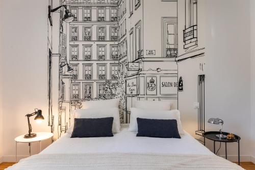 a bedroom with a white bed with a wall with buildings at Château Puybarban in Puybarban