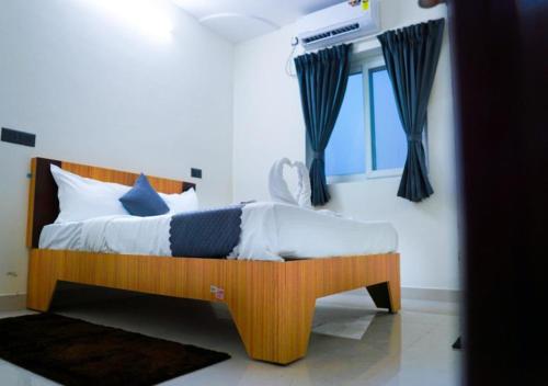 a bedroom with a wooden bed in a room at NRI Hotels & Coliving in Hyderabad