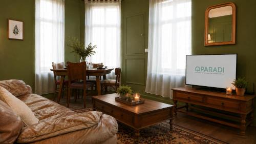 a living room with a couch and a flat screen tv at Oparadi 'L'Authentique' in Wimereux